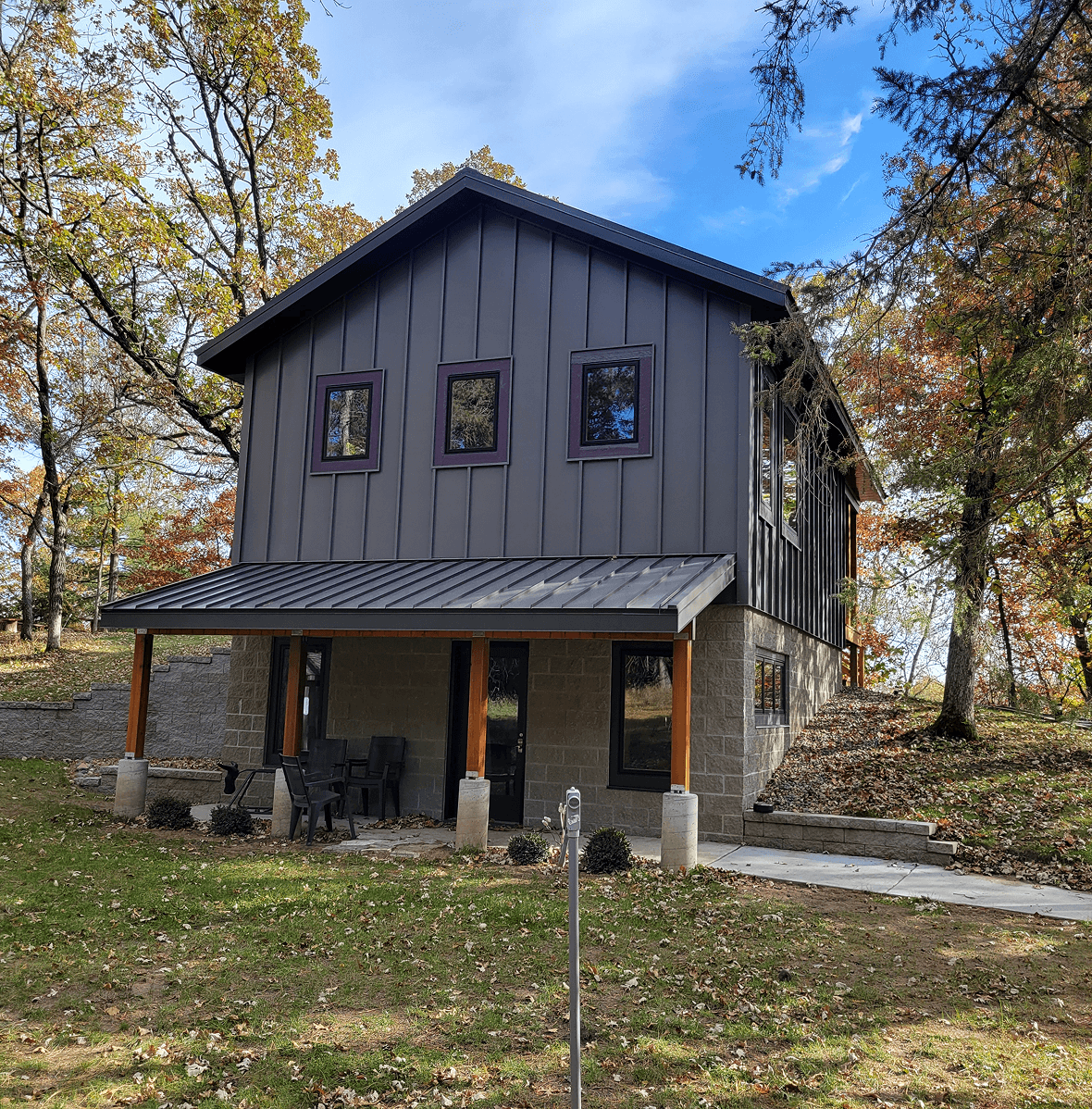 Two-story cabin in wooded area