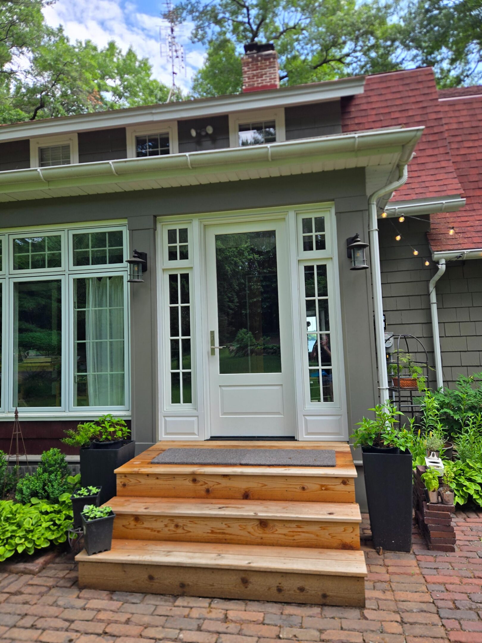 Front entrance with white French doors, wooden steps