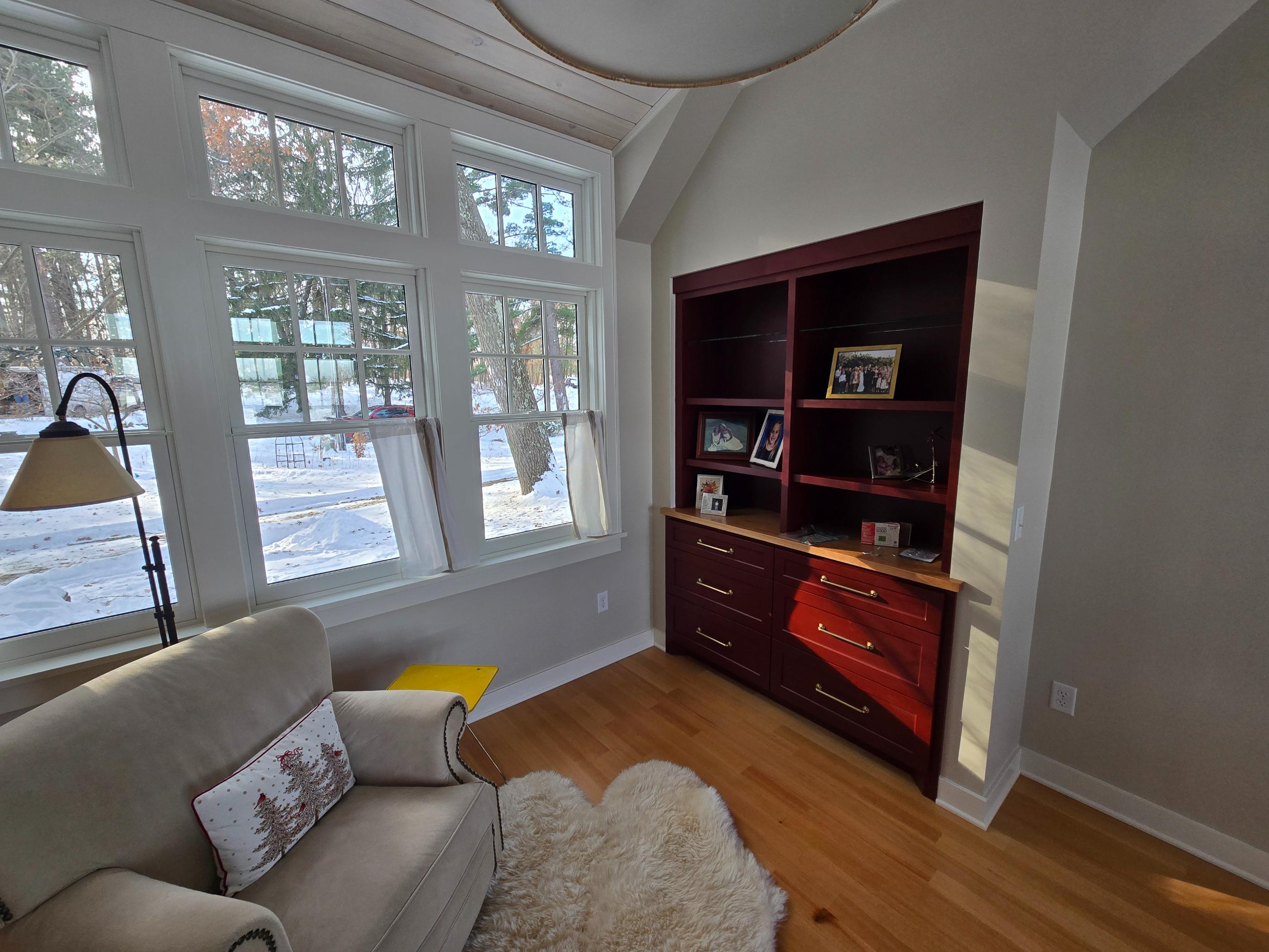 Cozy sunlit nook with armchair and built-ins