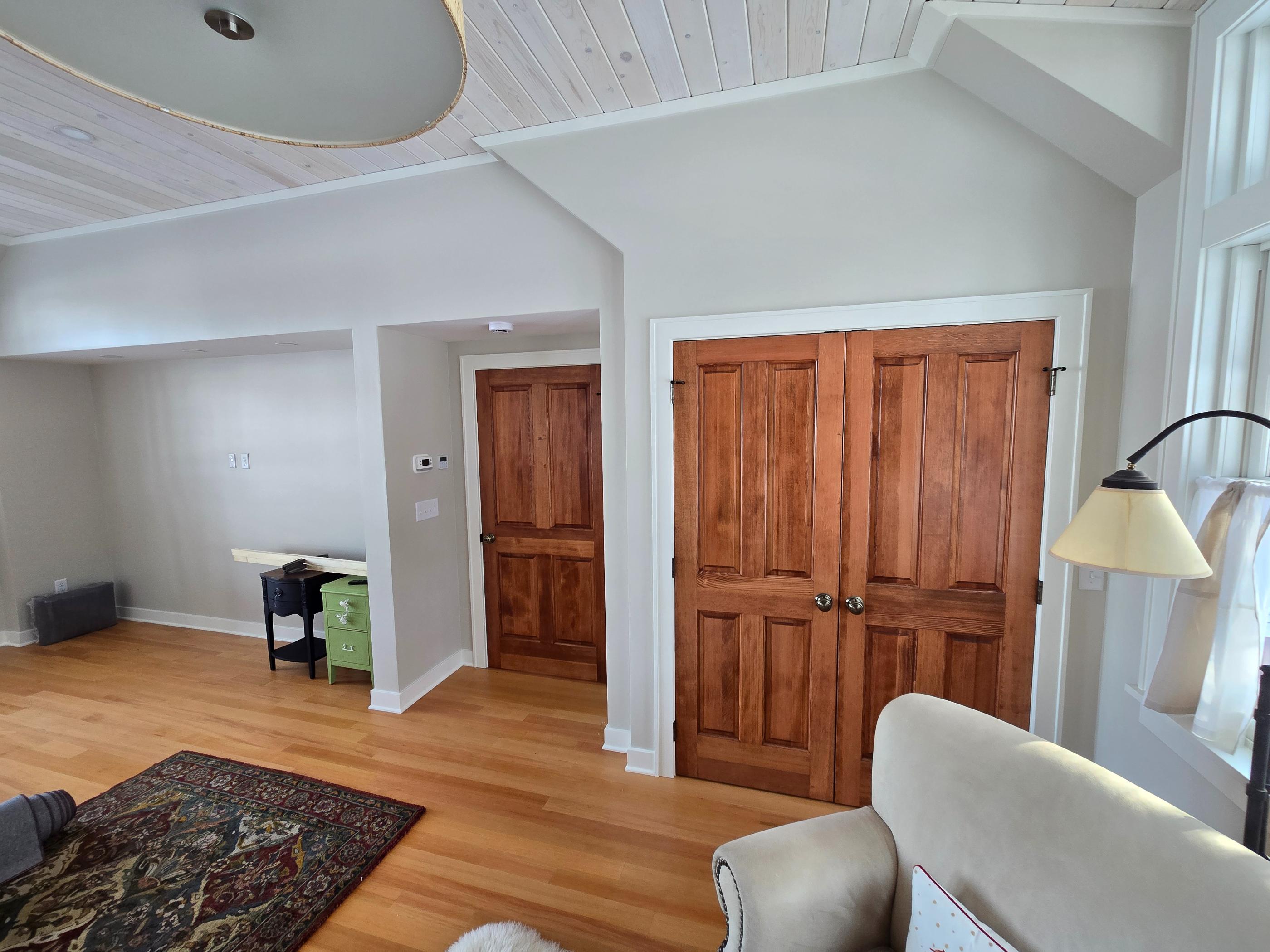 Bright living room with wooden double closet doors