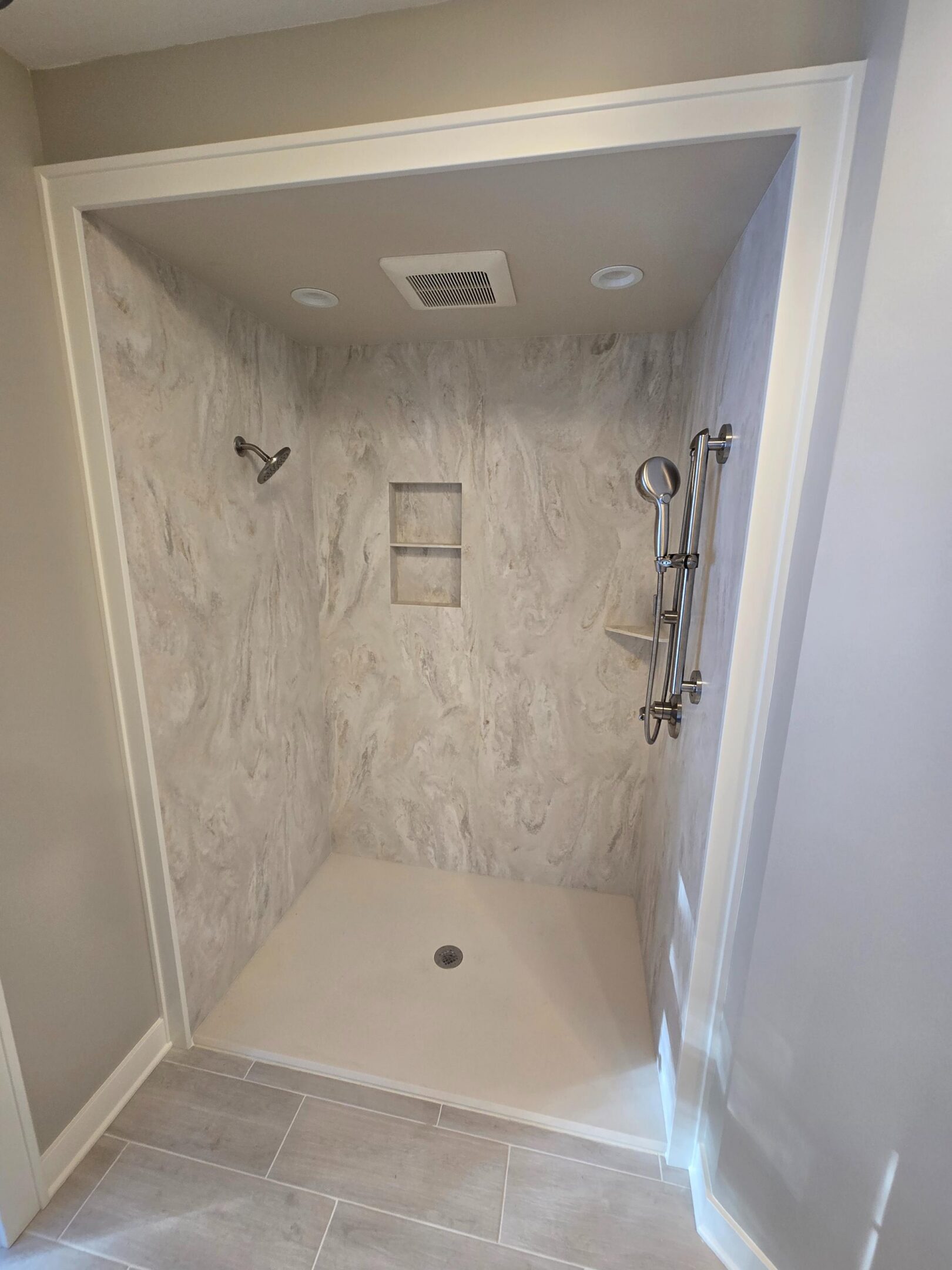 Walk-in shower with marble-pattern walls