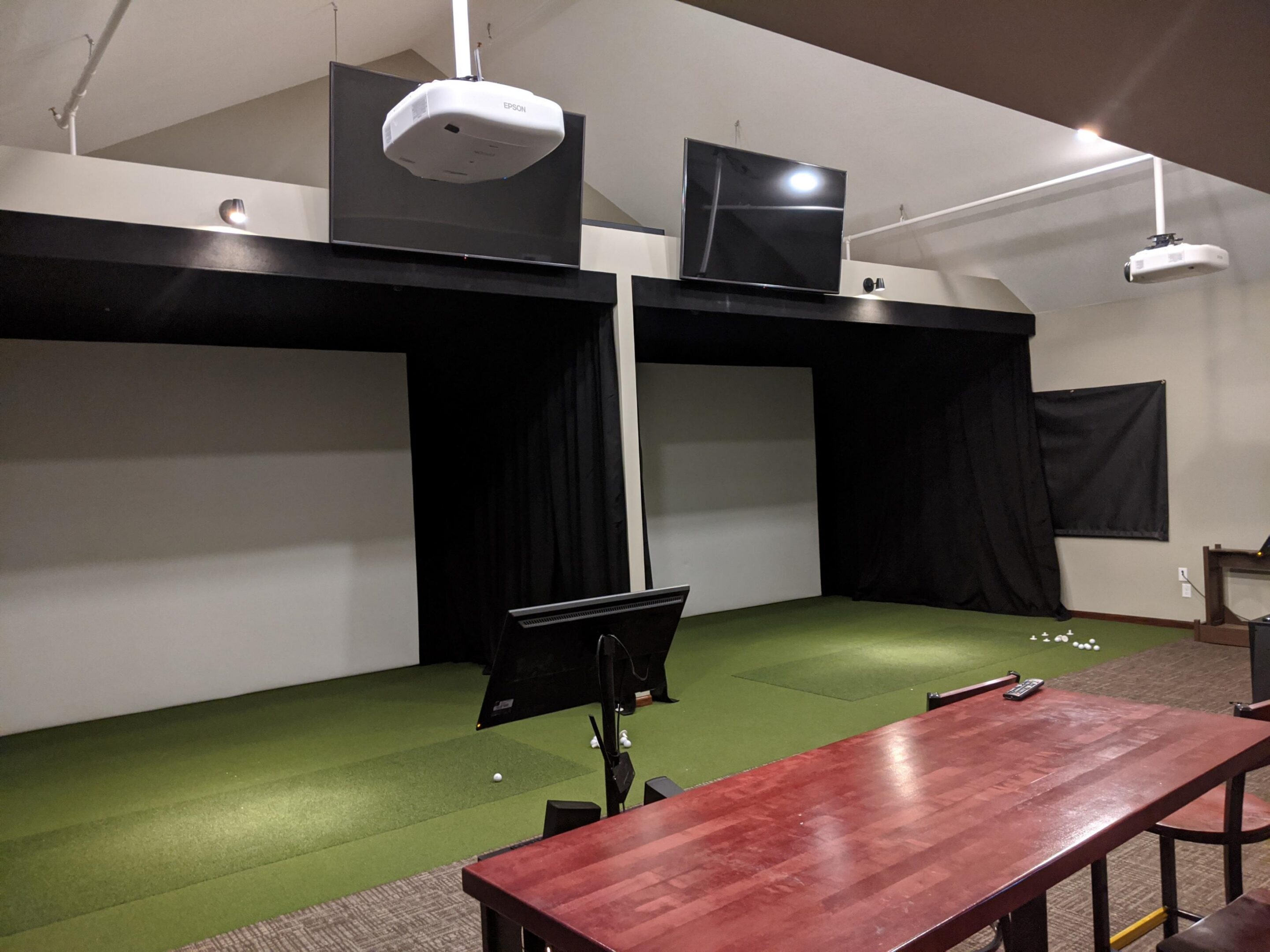 Indoor golf simulator with turf and balls
