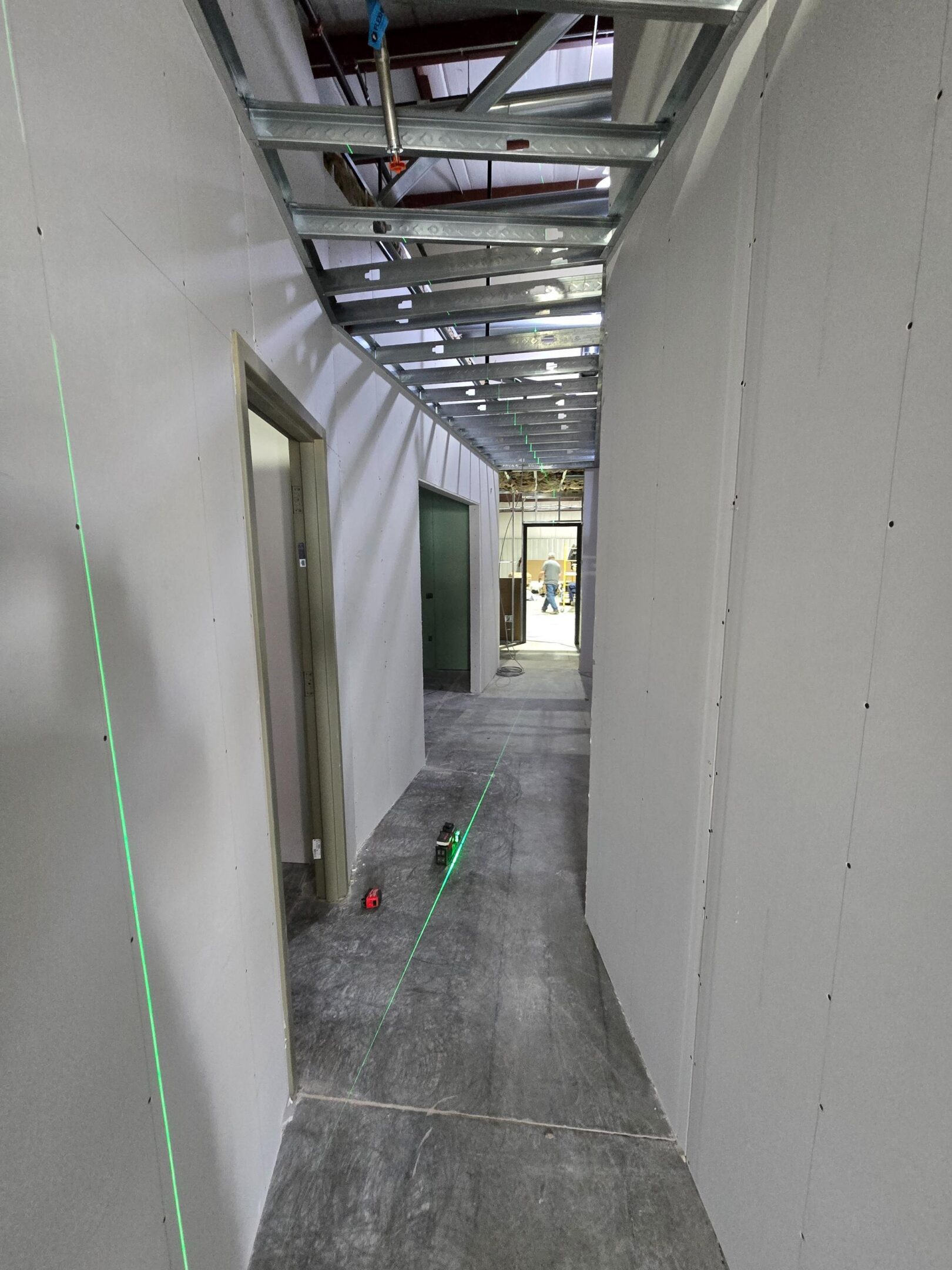 Interior construction hallway with drywall and metal framing