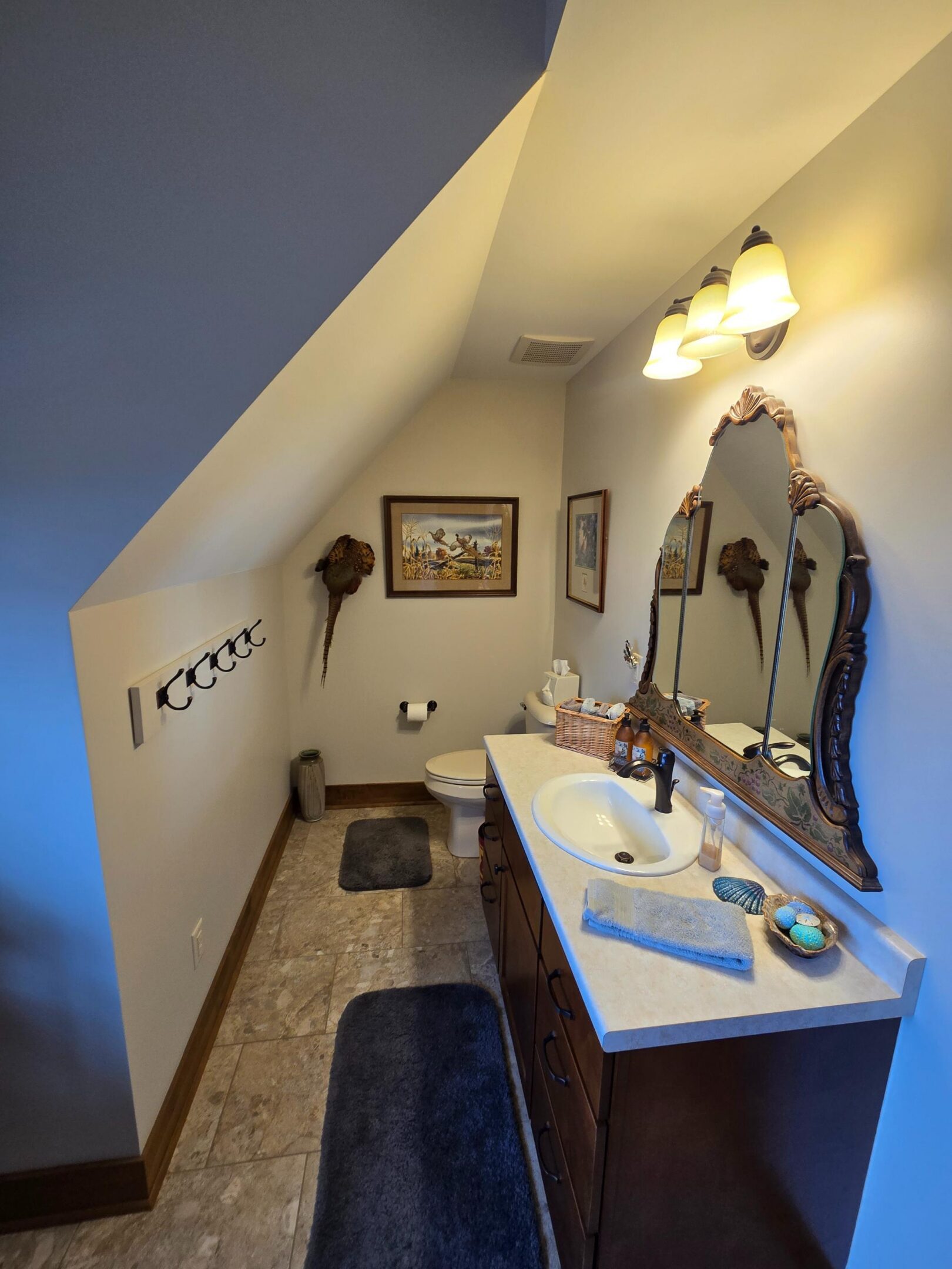 Small attic bathroom with vanity and mirror