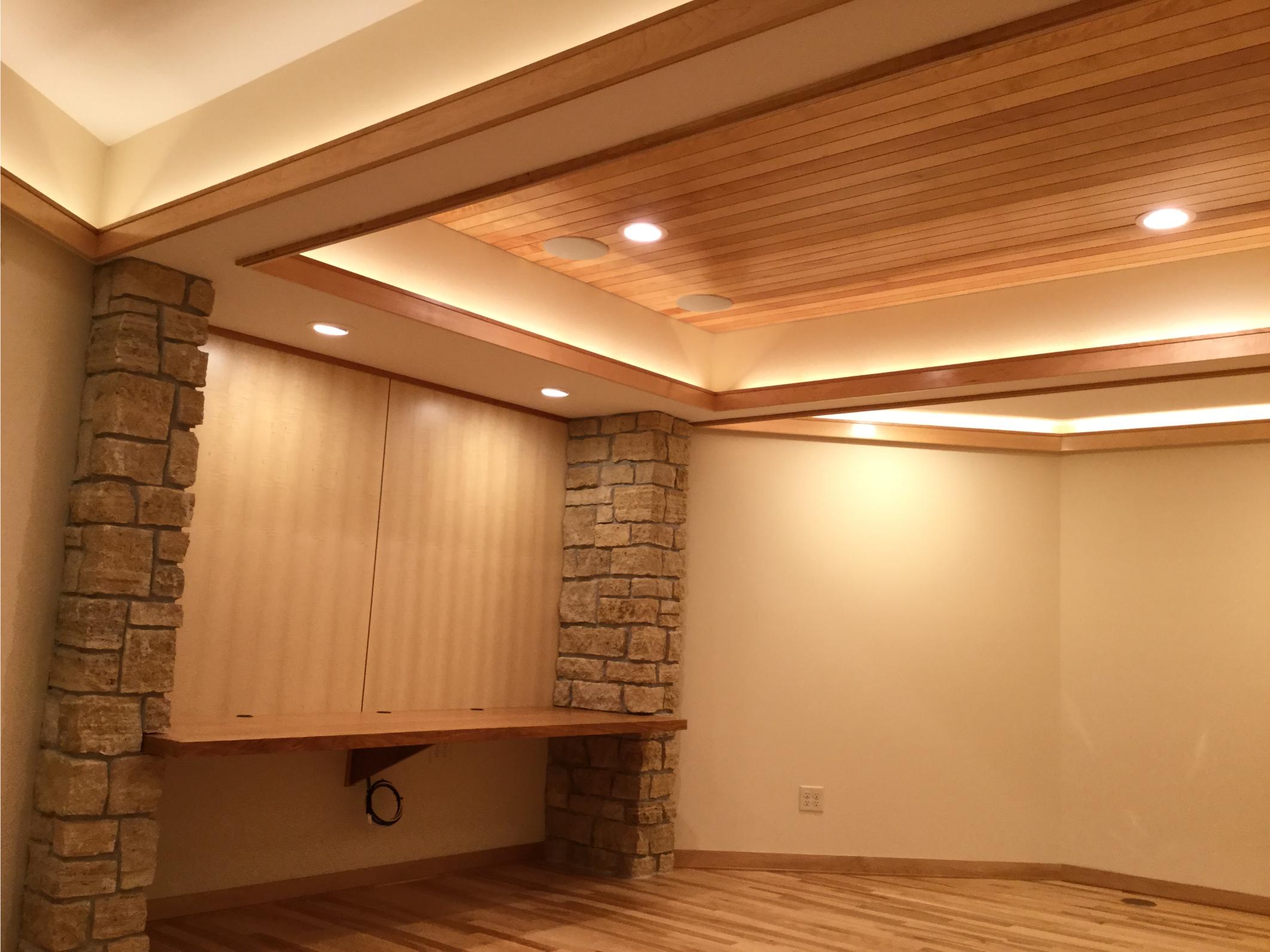 Basement room with wood ceiling and stone columns