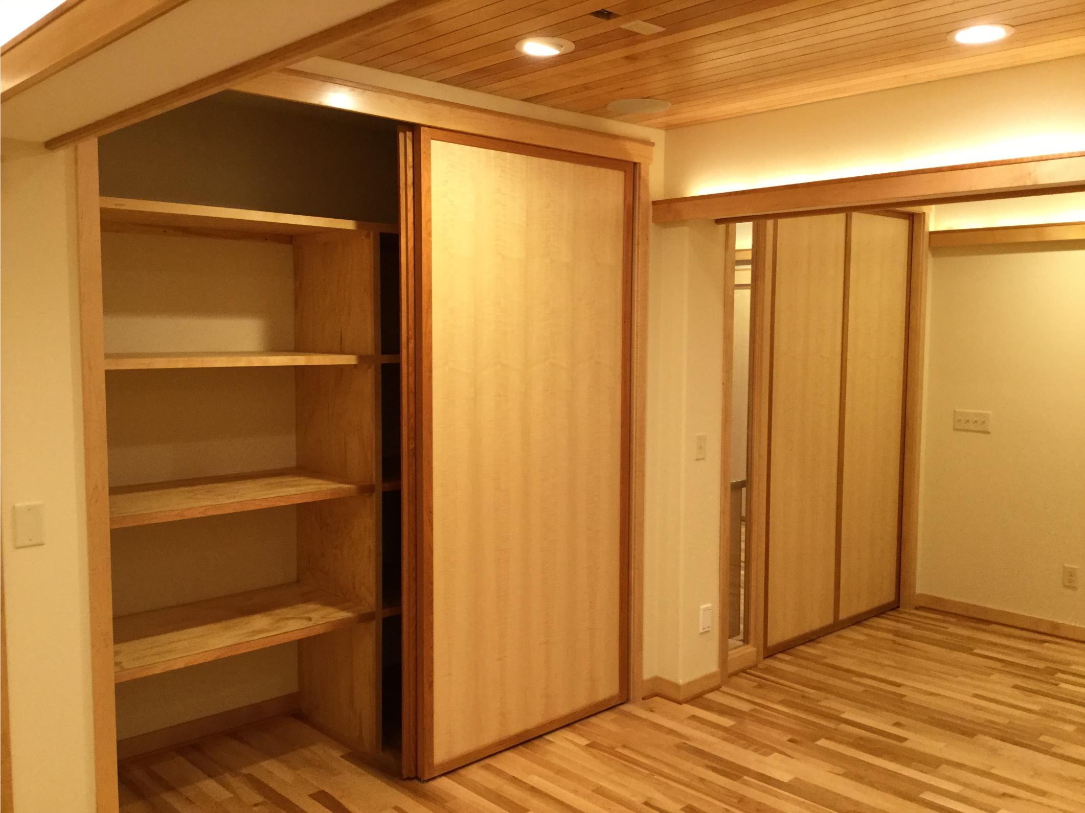 Wood-paneled room with sliding closet doors