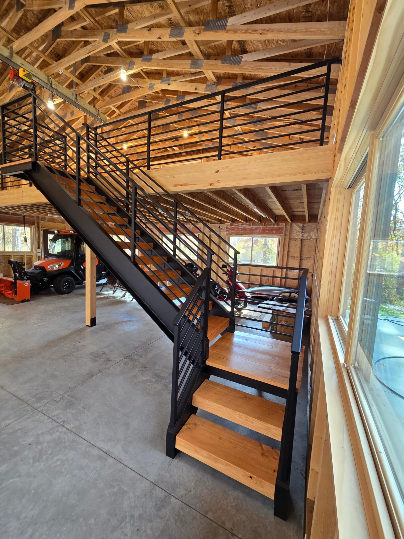 Modern industrial wooden staircase leading to loft