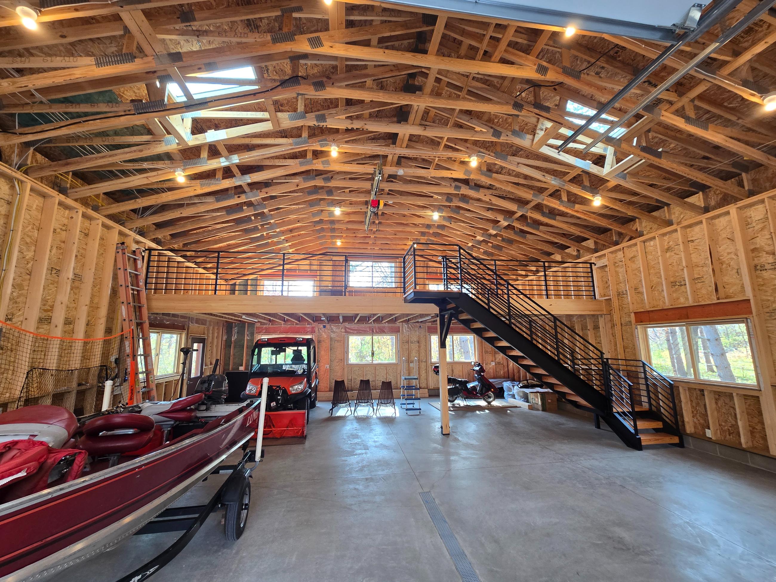Large wooden garage interior with boat and mezzanine