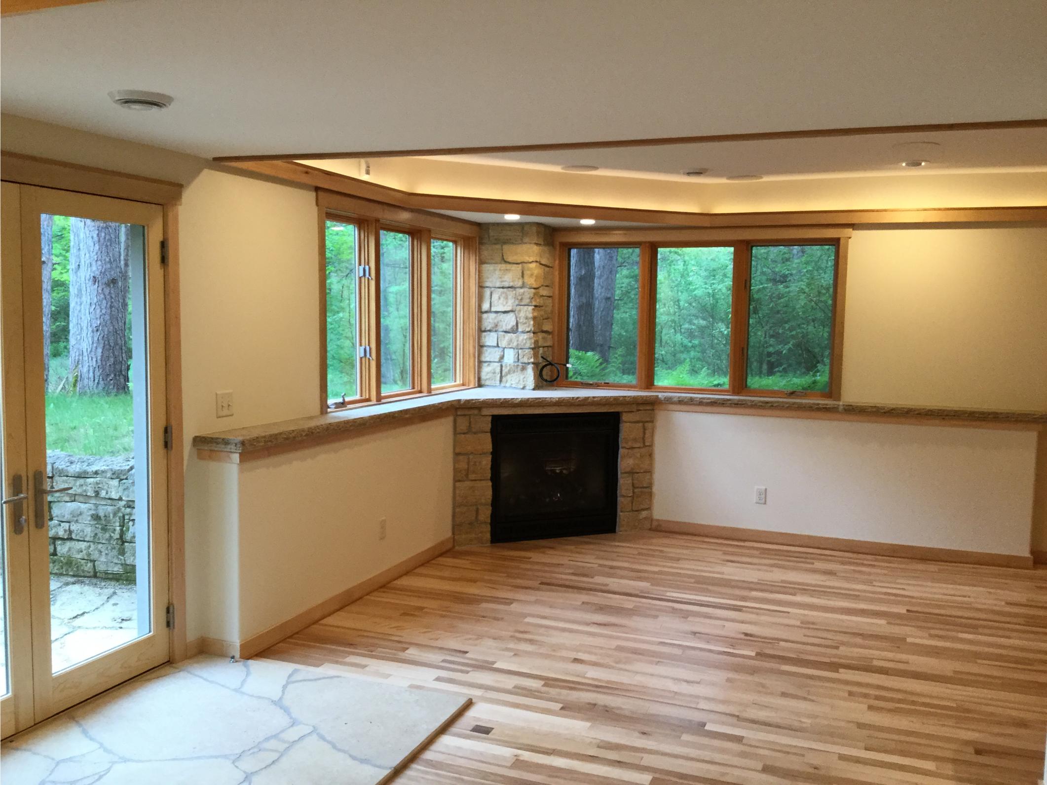 Empty living room with fireplace and bay windows