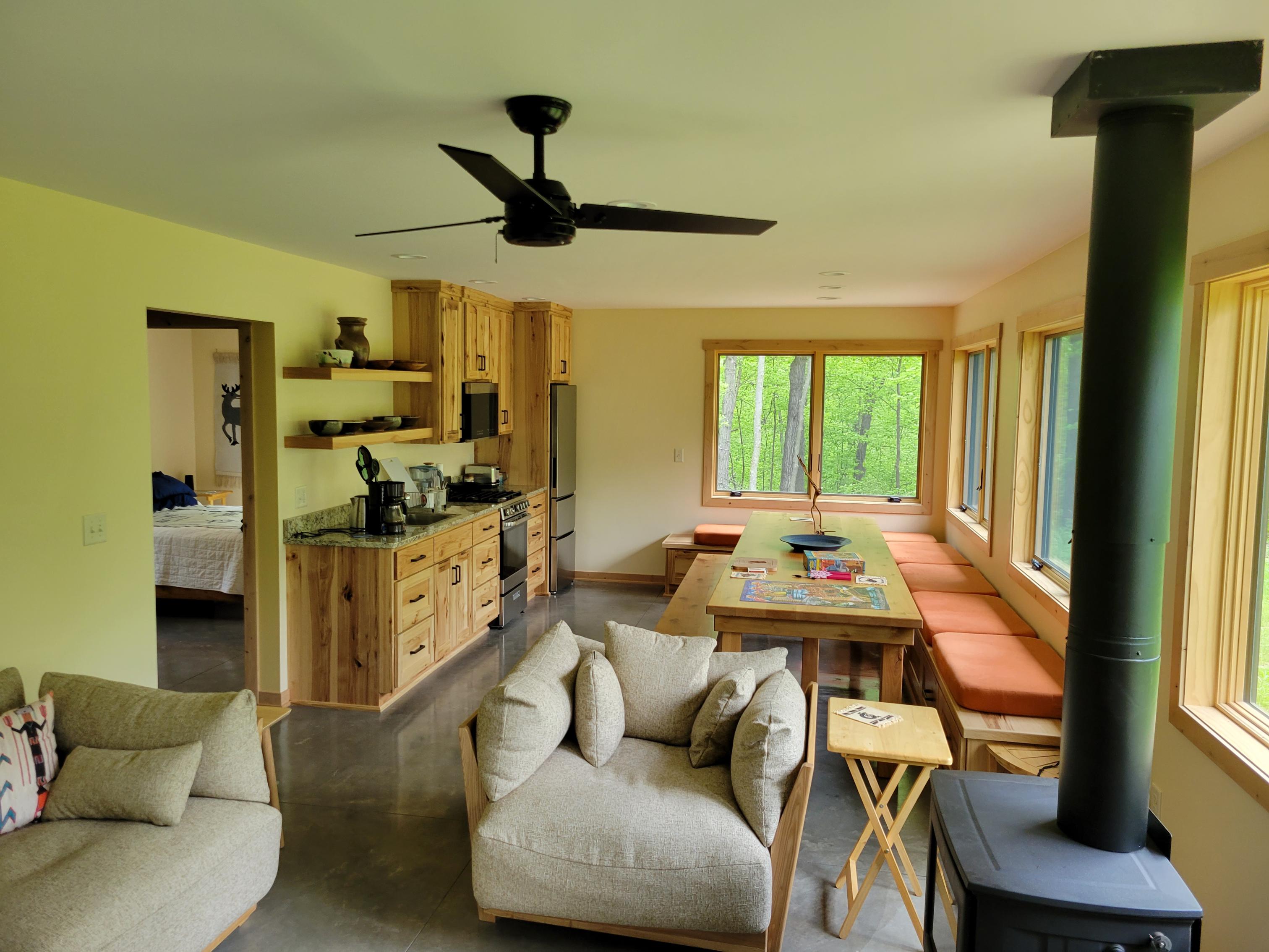 Cozy open-plan cabin interior with wood stove