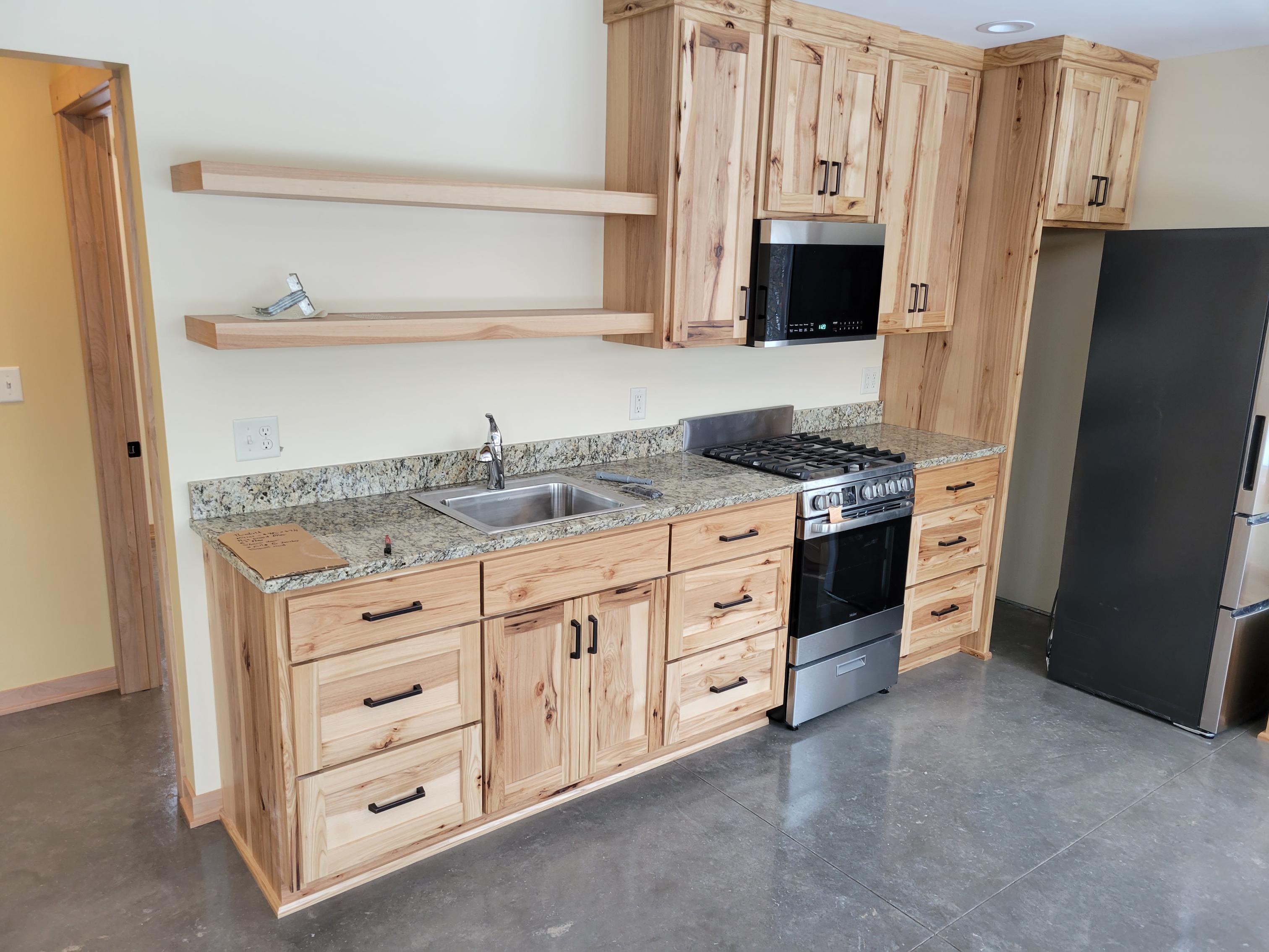 Kitchen with natural wood cabinets and granite countertop