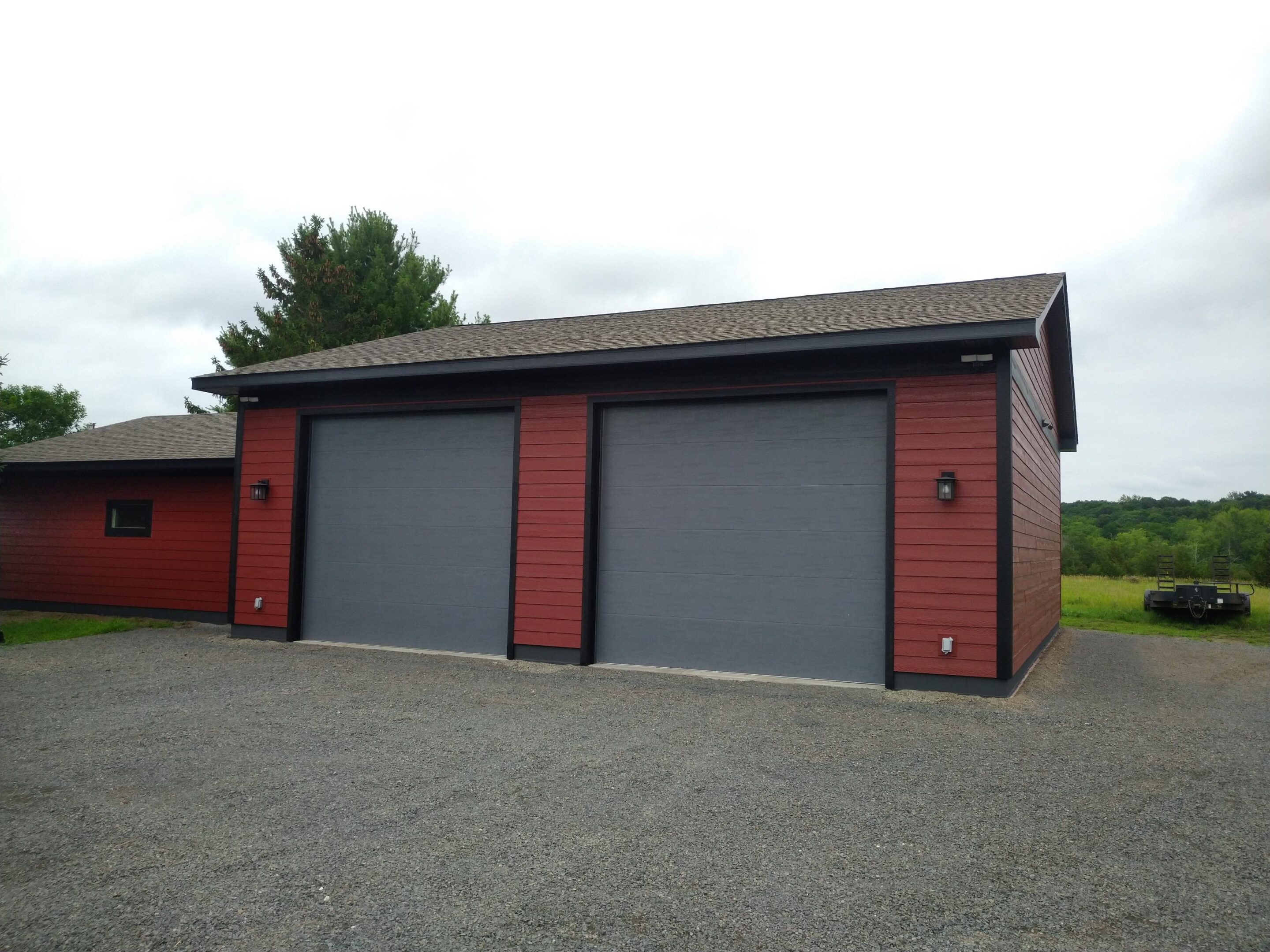 Red garage with two large gray doors