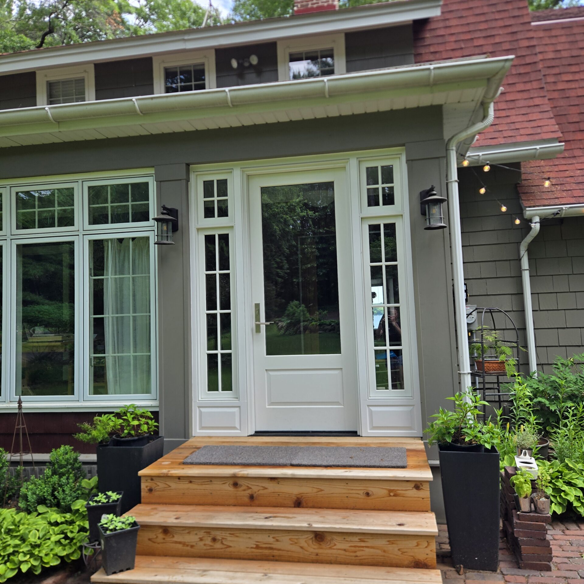 Front entrance with wooden steps and glass door